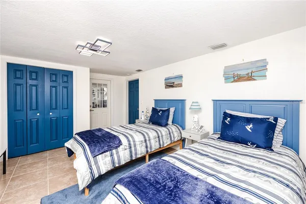 a bedroom with bed and a chandelier