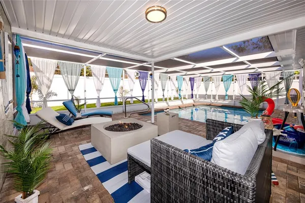 a dining room with furniture and a floor to ceiling window