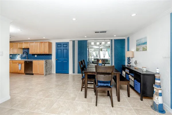 a view of a dining room with furniture and a kitchen