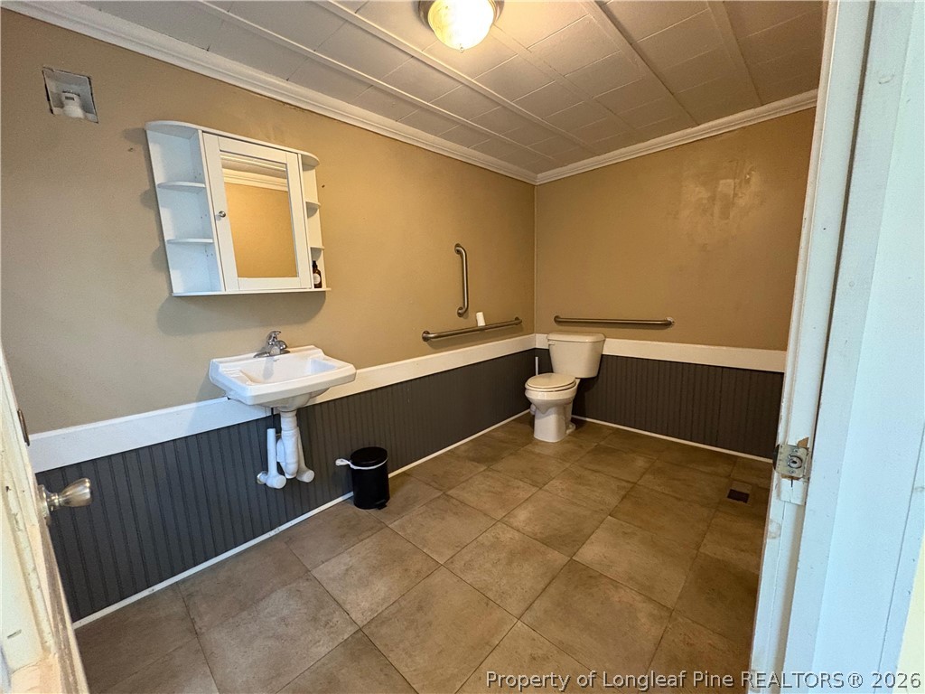 3174 Lindsay Road Raeford, NC 28376 - Photo 12 of 28 a bathroom with a sink mirror and toilet