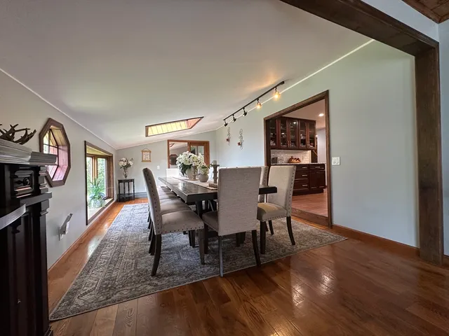 a dining room with furniture and wooden floor