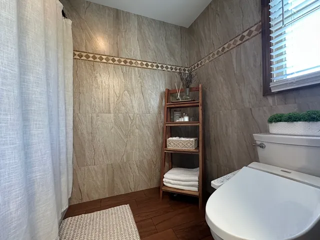 a bathroom with a toilet and a shower