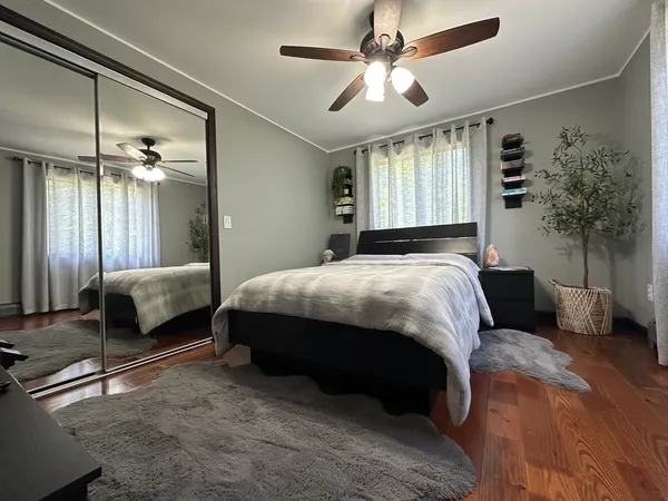 a bedroom with a bed a chandelier and couch