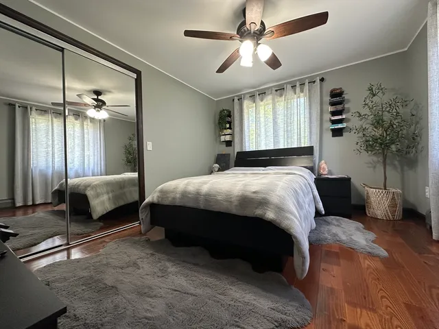 a bedroom with a bed a chandelier and couch