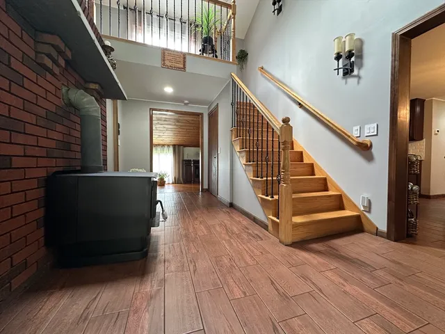 a view of entryway and hall with wooden floor