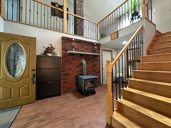 a view of entryway with wooden floor and a front door