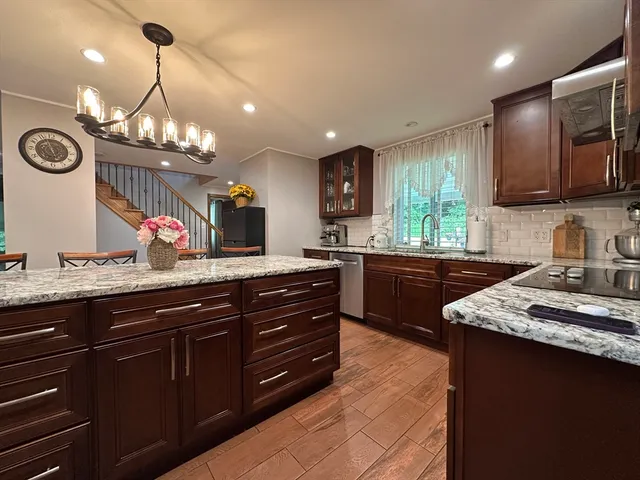 a kitchen with a sink and a stove with cabinets