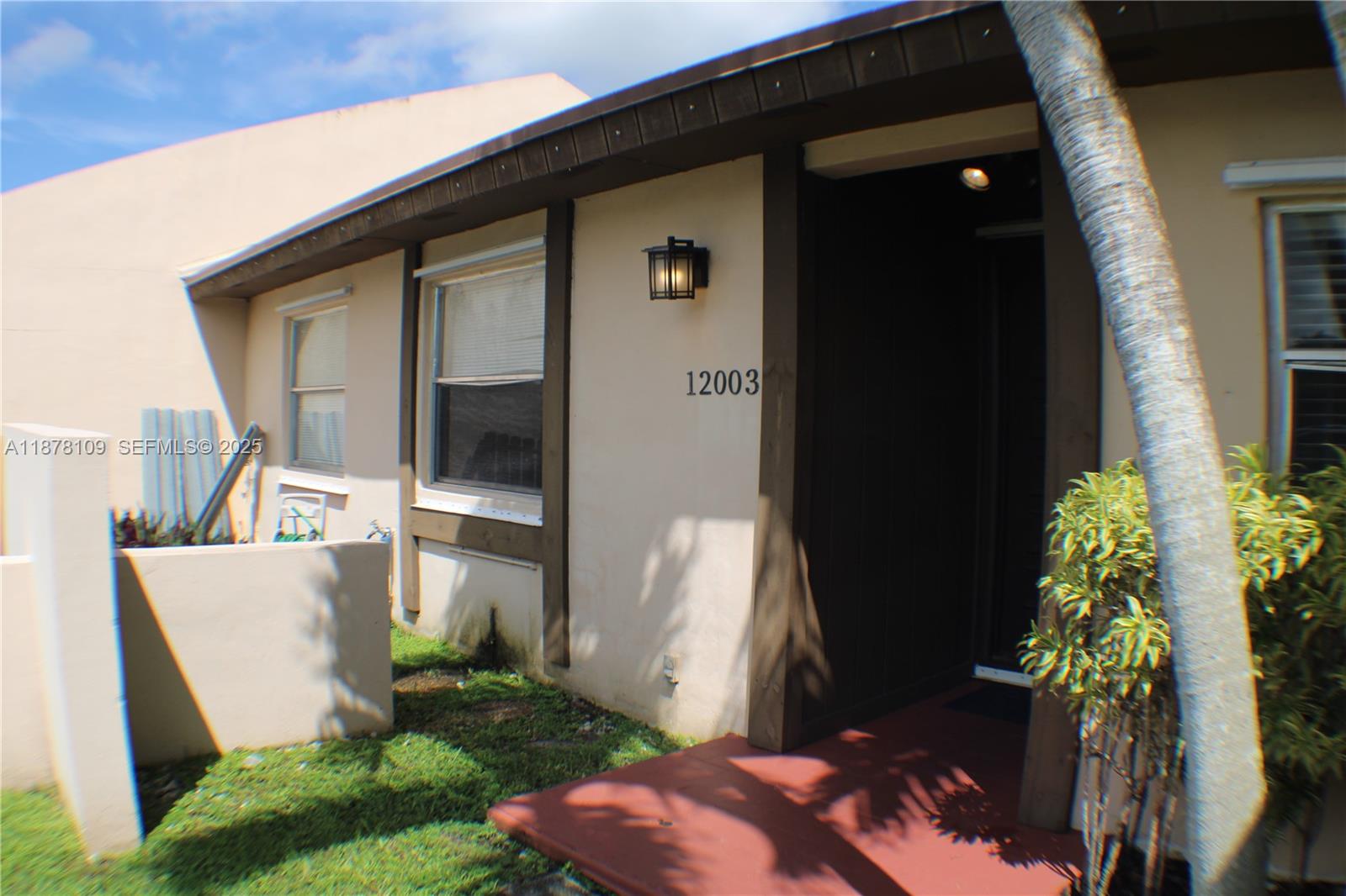 12003 Southwest 110th St Circle North Miami, FL 33186 - Photo 11 of 12 a front view of a house with a yard