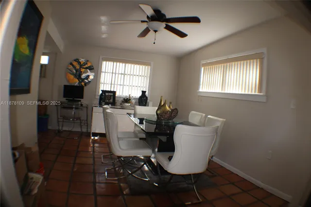 a dining room with furniture and window
