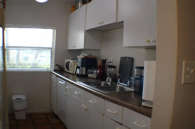 a kitchen with a sink and cabinets