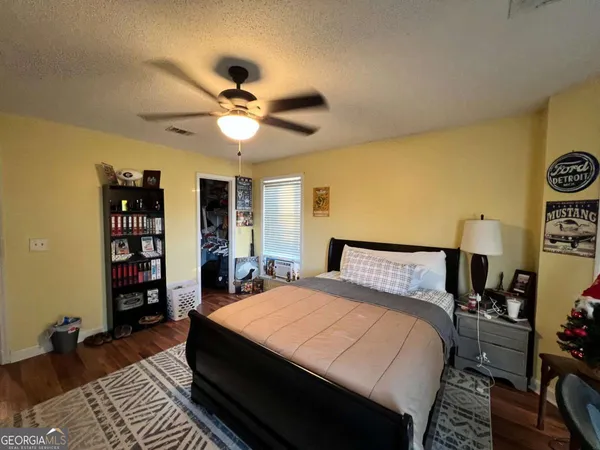 a very nice looking room with wooden floor and furniture