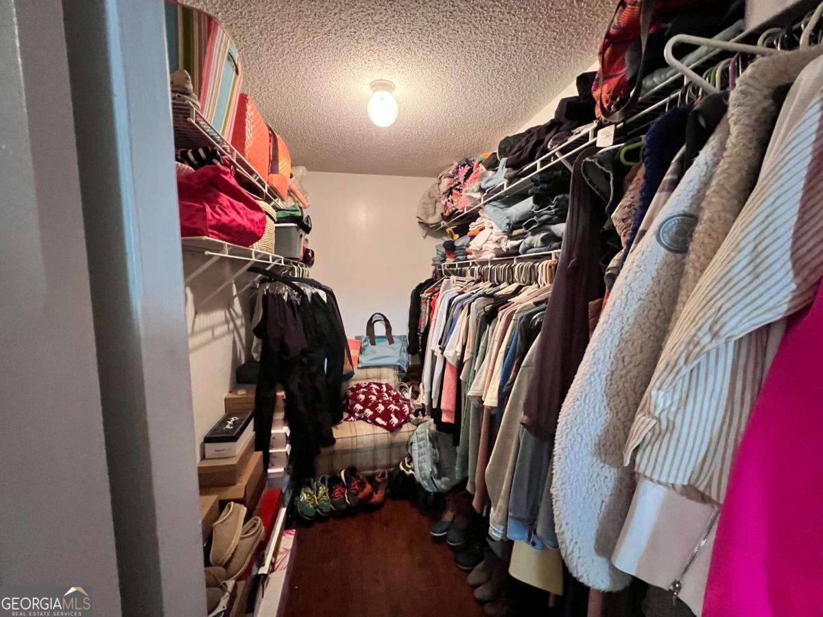 2003 Chevy Place Vidalia, GA 30474 - Photo 16 of 26 a view of walk in closet with clothes