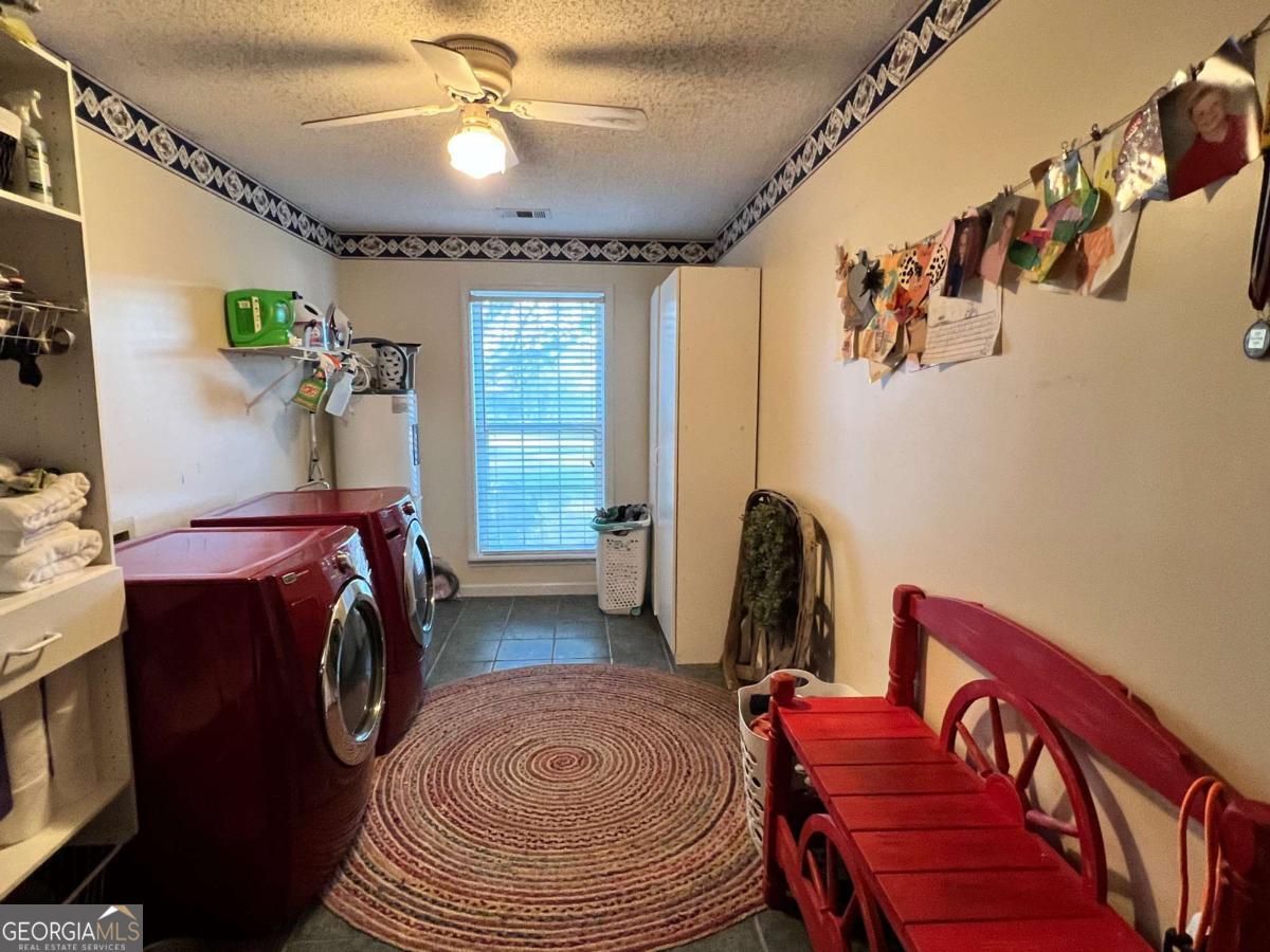 2003 Chevy Place Vidalia, GA 30474 - Photo 2 of 26 a bedroom with a bed and a chandelier