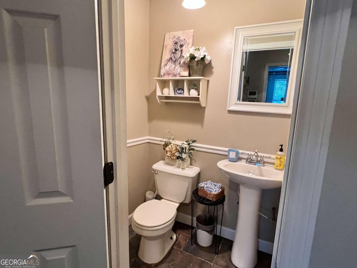 2003 Chevy Place Vidalia, GA 30474 - Photo 22 of 26 a bathroom with a toilet sink and mirror