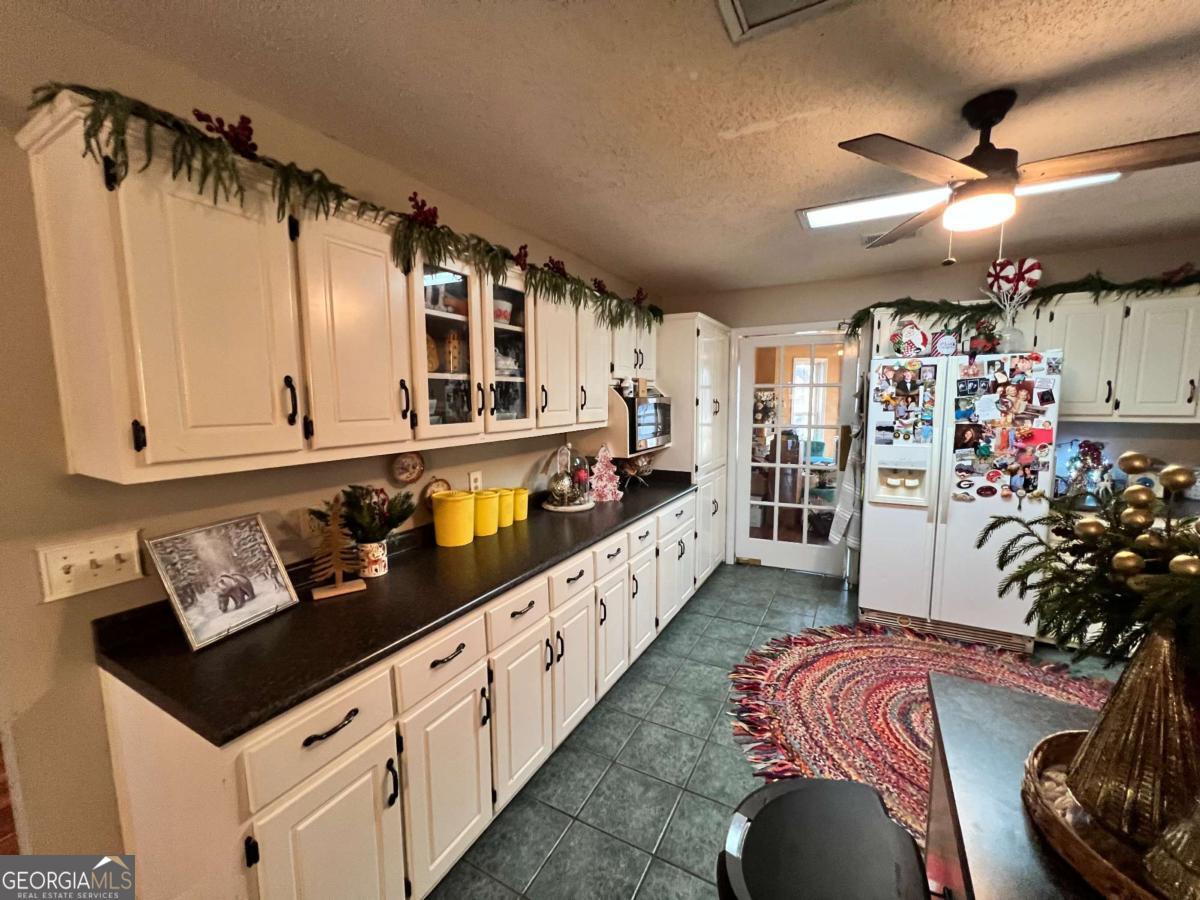 2003 Chevy Place Vidalia, GA 30474 - Photo 4 of 26 a open kitchen with stainless steel appliances granite countertop a refrigerator a oven a sink and dishwasher with wooden floor
