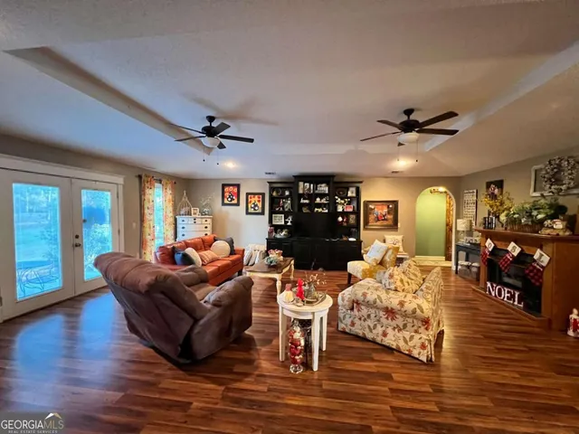 a living room with furniture and wooden floor