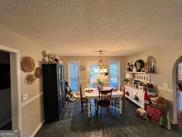 a view of a dining room with furniture and a chandelier