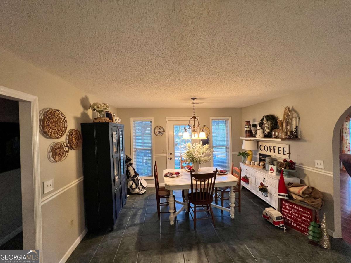2003 Chevy Place Vidalia, GA 30474 - Photo 8 of 26 a view of a dining room with furniture and a chandelier
