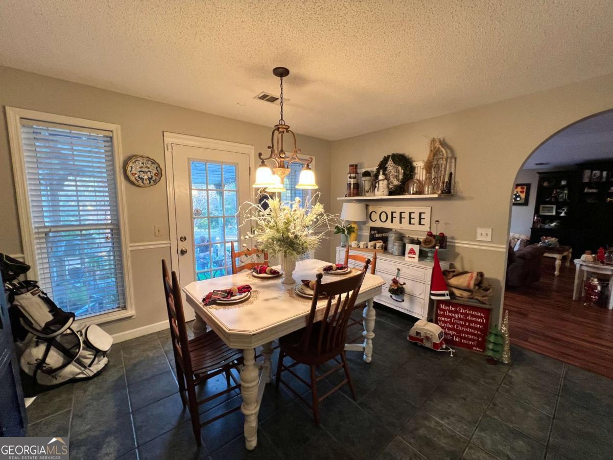 2003 Chevy Place Vidalia, GA 30474 - Photo 9 of 26 a view of a dining room with furniture and chandelier