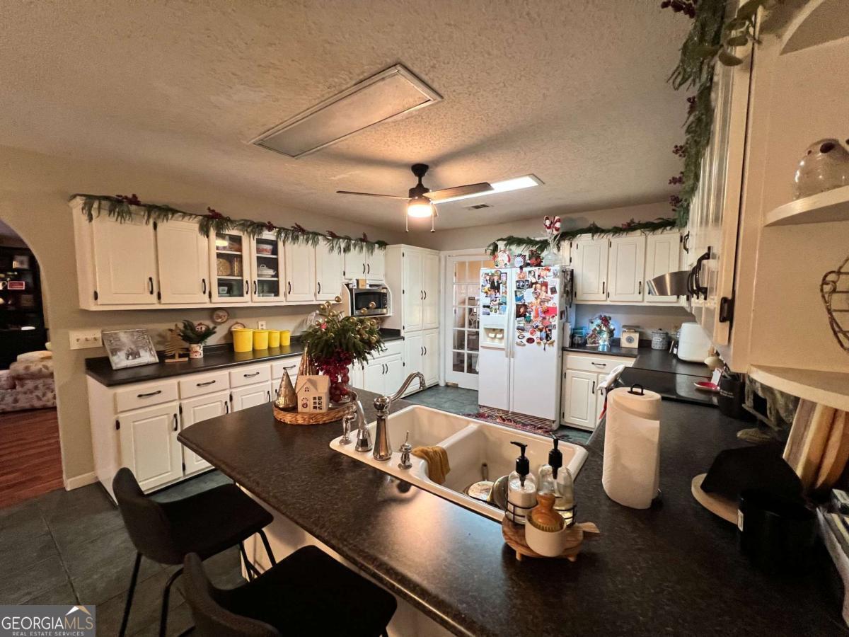 2003 Chevy Place Vidalia, GA 30474 - Photo 10 of 26 a room with stainless steel appliances kitchen island granite countertop lots of counter top space