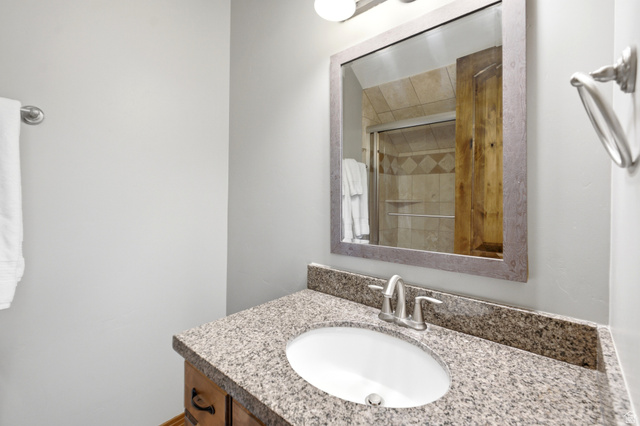 3148 Lower Saddleback Road Park City, UT 84098 - Photo 33 of 67 Bathroom vanity with a granite countertop, undermount sink, and brushed nickel faucet