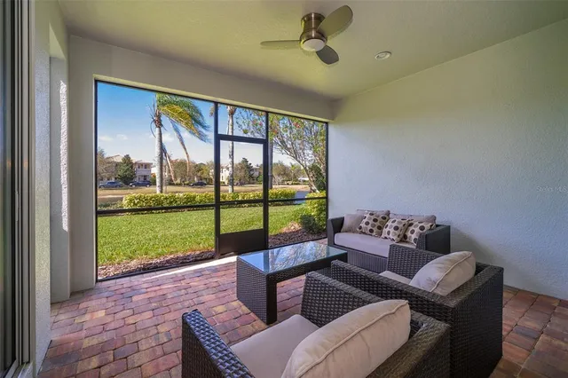 a living room with couch and a floor to ceiling window