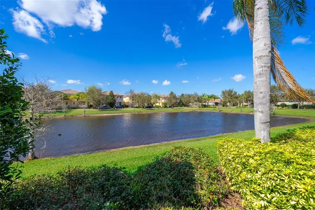 a view of a lake with houses in the back
