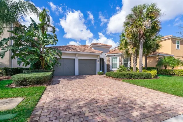 a front view of a house with a garden and yard