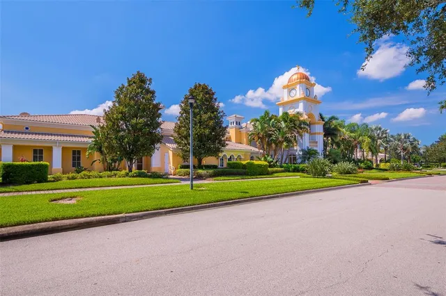 a green field with some trees in front of it