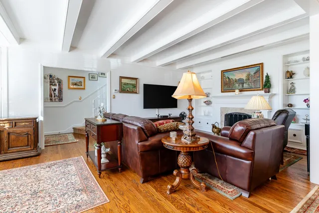 a living room with furniture and a lamp