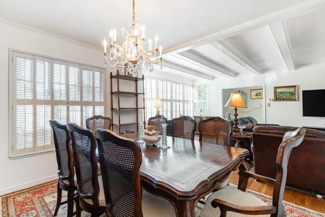 a view of a dining room with furniture and chandelier