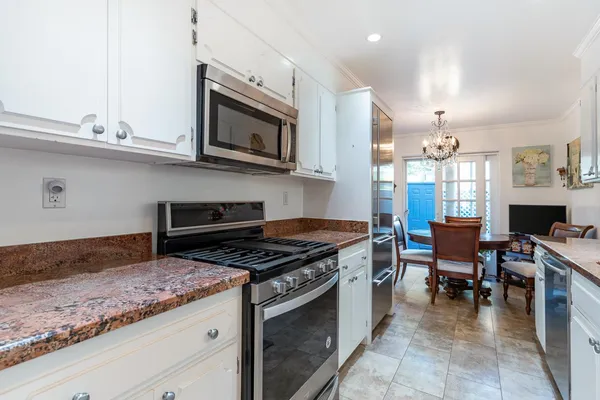 a kitchen with a sink stove and cabinets