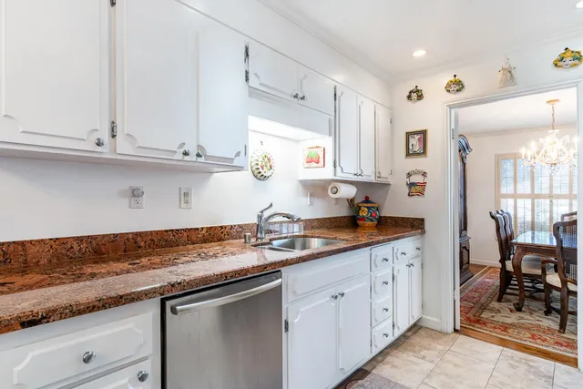 a kitchen with granite countertop a dining table and chairs