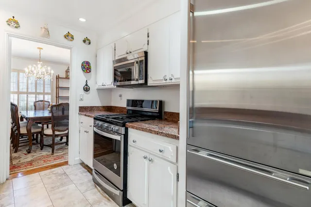 a kitchen with stainless steel appliances granite countertop a sink stove and cabinets