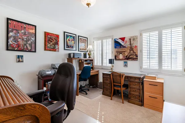 a view of a workspace with furniture and a workspace