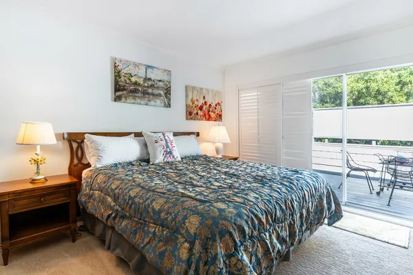a large bedroom with a bed and a flat screen tv