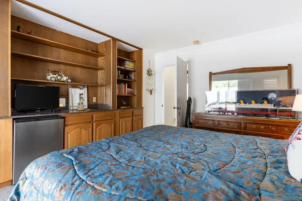 a bedroom with a bed and window