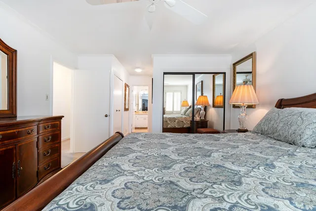 a view of a hallway with wooden floor and closet