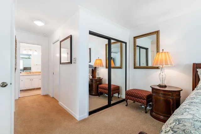 a bathroom with a granite countertop sink toilet a mirror a vanity and shower