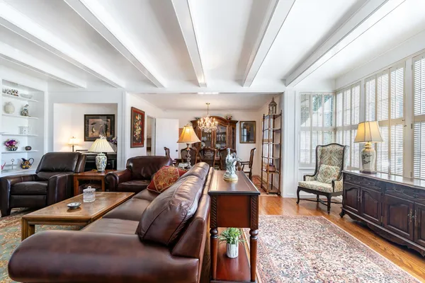 a living room with furniture fireplace and a large window