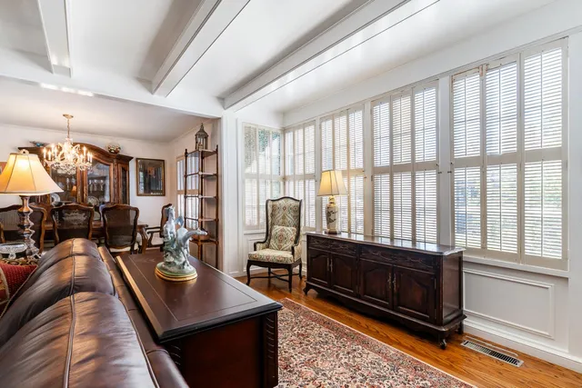 a living room with furniture a rug and a large window
