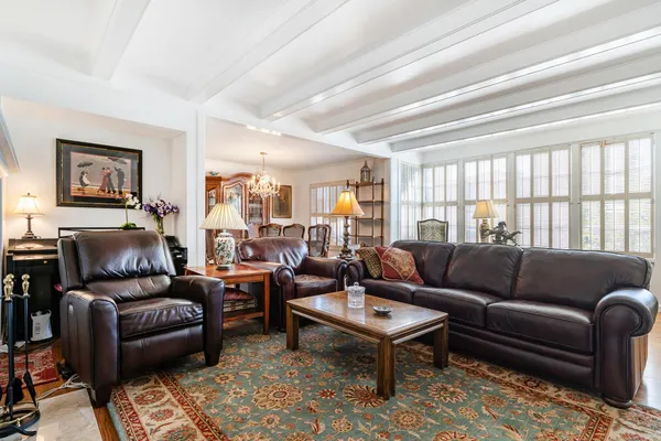 a living room with furniture fireplace and a window