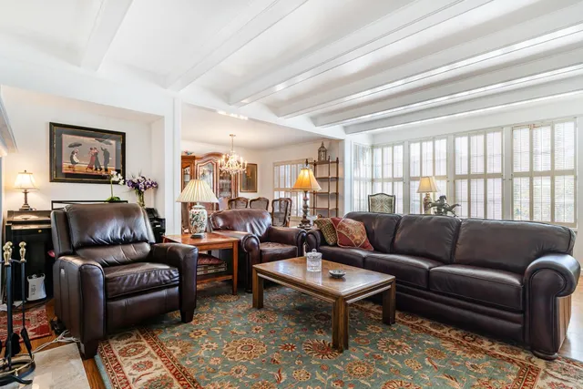 a living room with furniture fireplace and a window