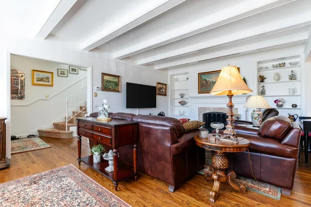 a living room with furniture and large windows