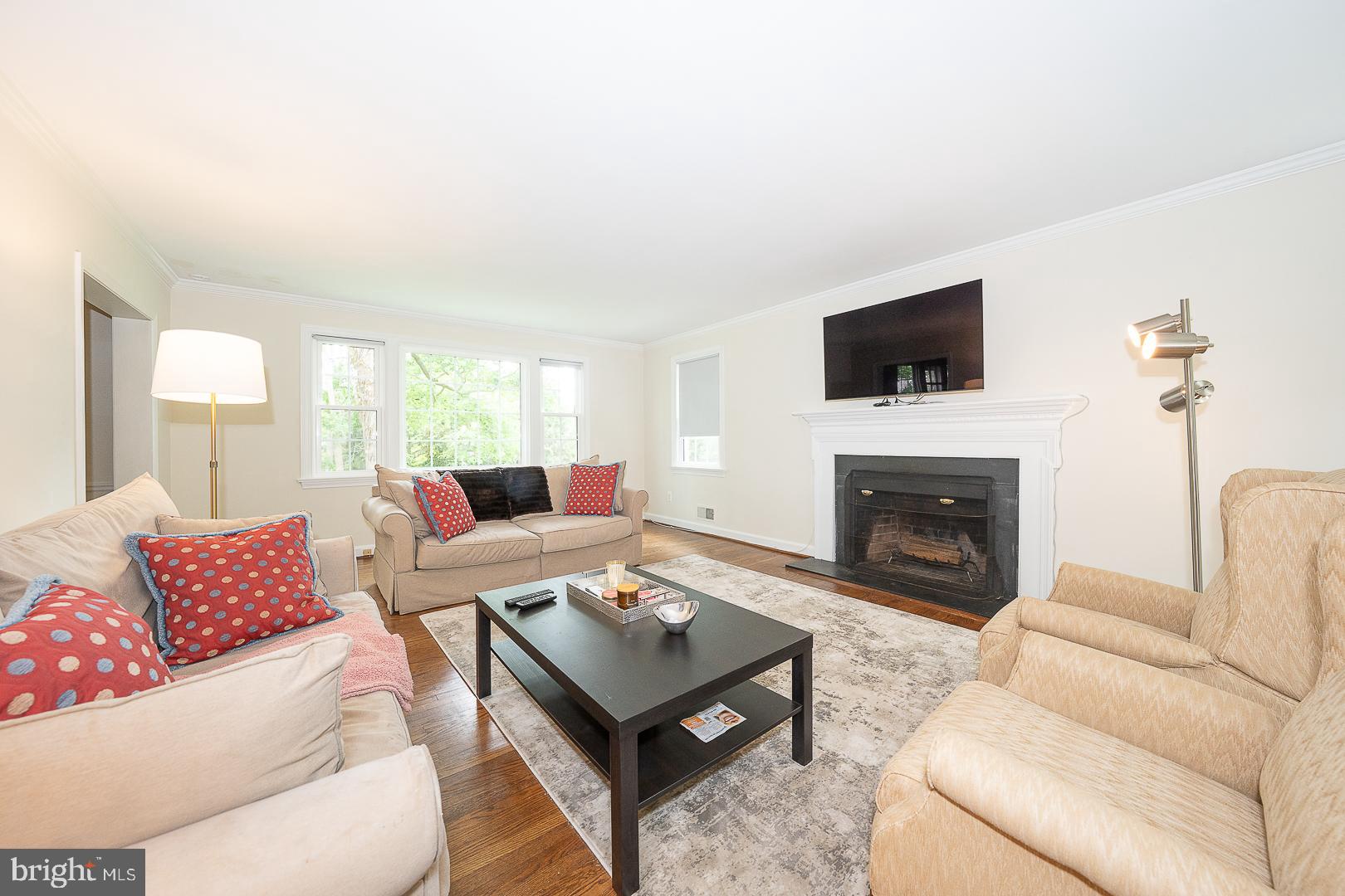 538 Conestoga Road Villanova, PA 19085 - Photo 7 of 39 a living room with furniture a fireplace and a flat screen tv