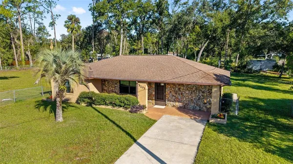 a view of a house with pool and a yard
