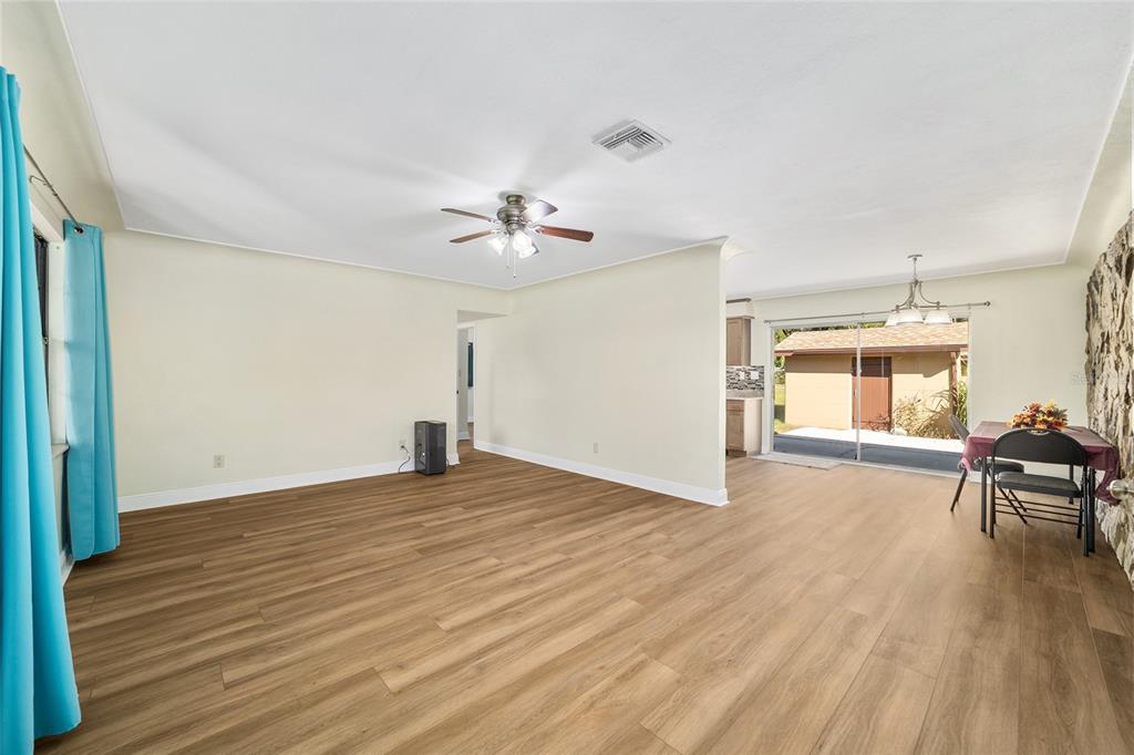 5201 East Jasmine Lane Inverness, FL 34453 - Photo 17 of 50 a view of empty room with wooden floor and fan