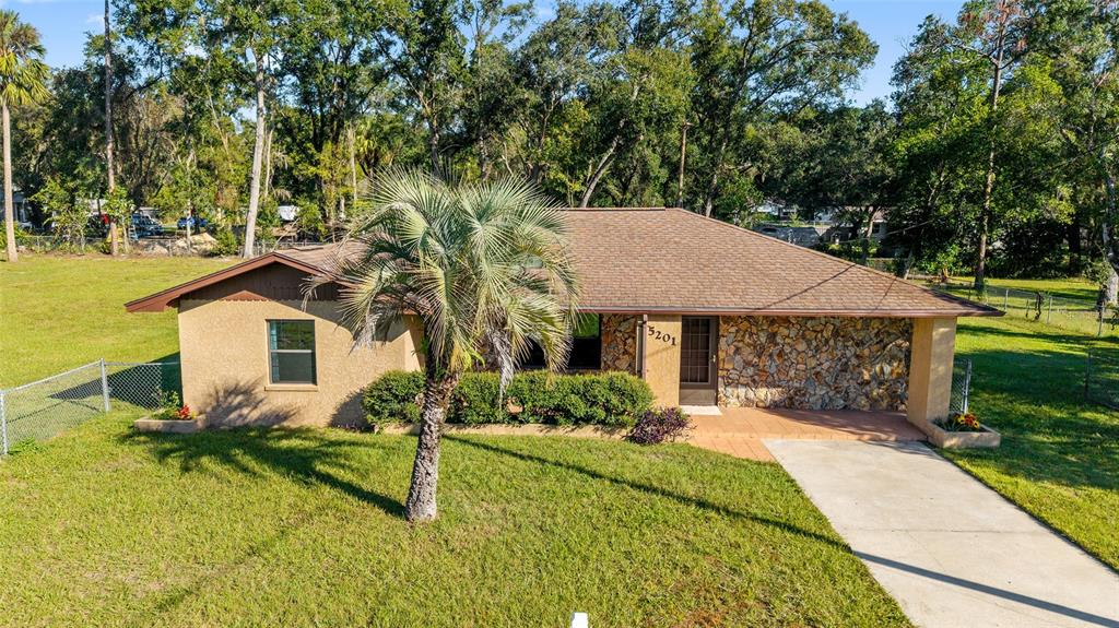 5201 East Jasmine Lane Inverness, FL 34453 - Photo 2 of 50 a front view of a house with a yard