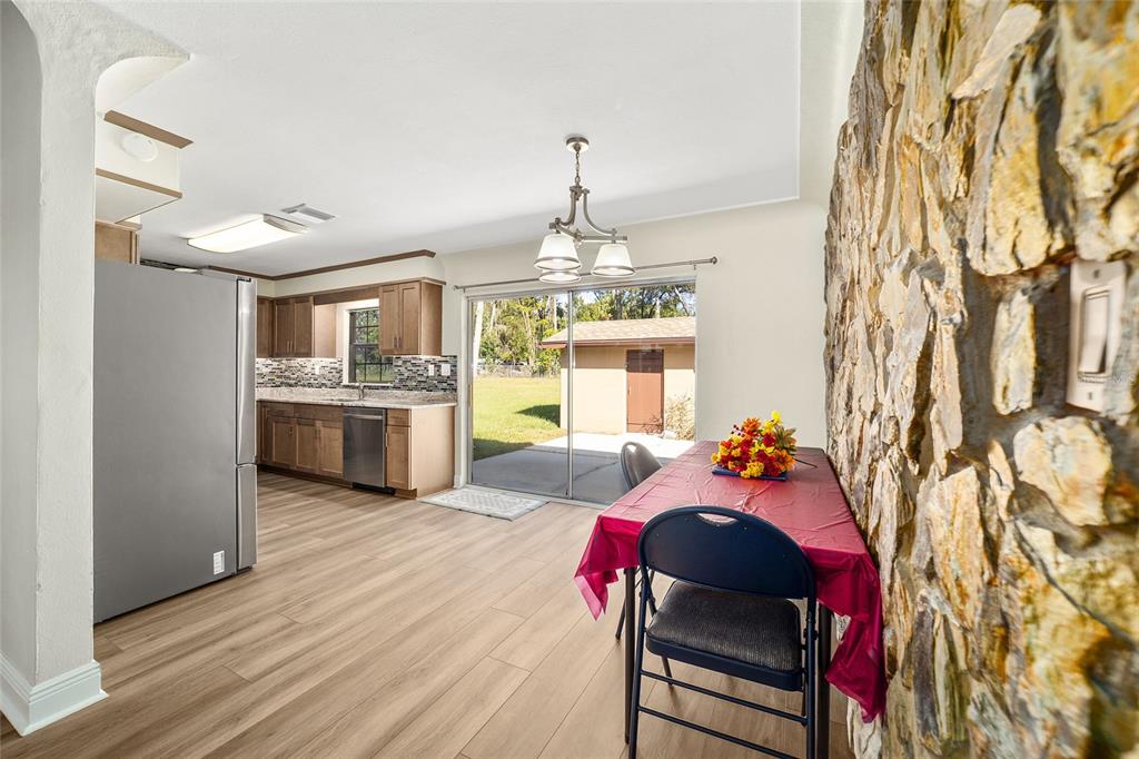 5201 East Jasmine Lane Inverness, FL 34453 - Photo 22 of 50 a living room with furniture and a chandelier