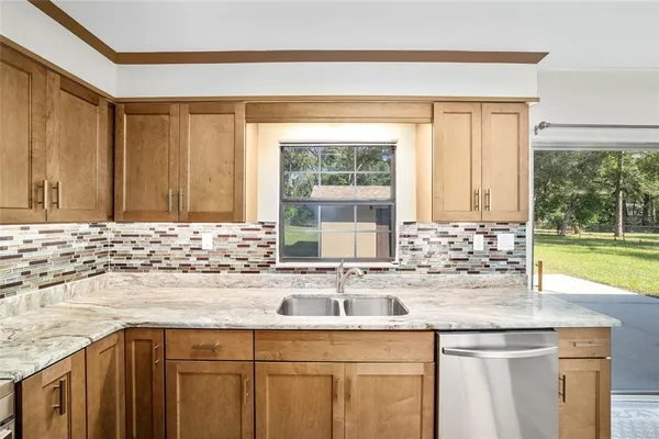 a view of a kitchen with a sink and refrigerator